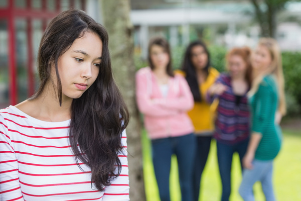 Female student being bullied by other group of students